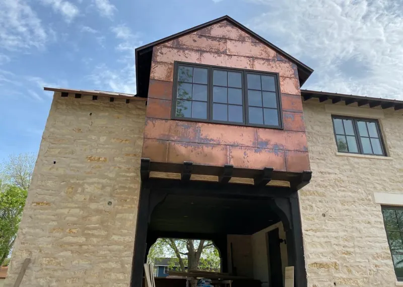 Copper metal panel facade on a stone building for Roof Repair in Wilsonville